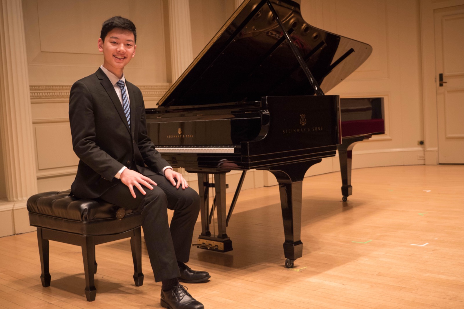 Seated on the bench beside the piano afterwards, smiling at the camera